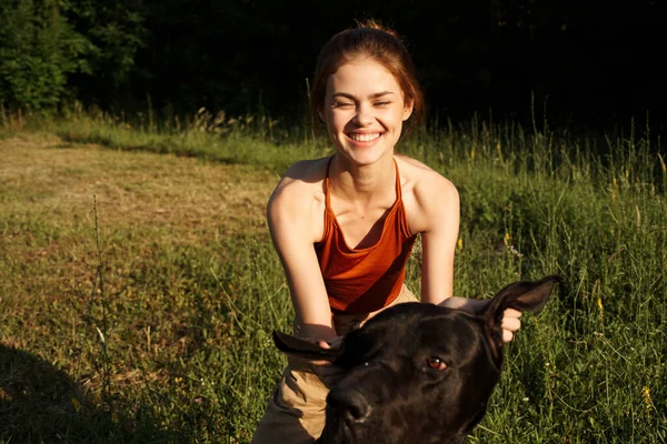 Kvinna utomhus på fältet med hund vänskap spelar — Stockfoto