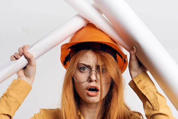 Female engineer in orange hard hat blueprints architect — Stock Photo, Image