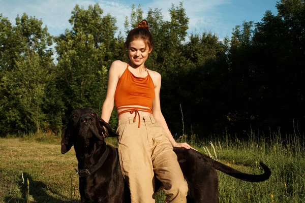 Cheerful woman outdoors with dog and fun nature — Stock Photo, Image