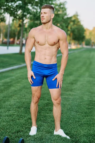 Hombre musculoso haciendo ejercicios al aire libre Fitness verano — Foto de Stock