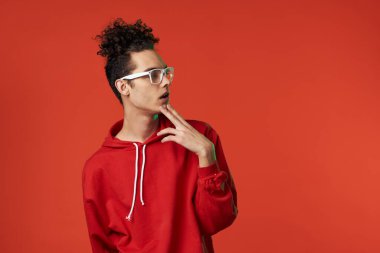 Kırmızı kazaklı bir adam kalp tatilinde poz veriyor.