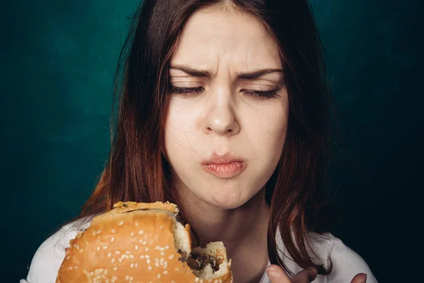 Žena jíst hamburger rychlé občerstvení zblízka — Stock fotografie