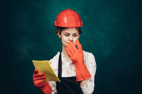 Woman in black apron orange hard hat protection cleaning — Stock Photo, Image