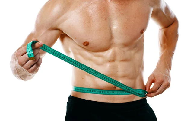 Hombre atlético con cinta métrica entrenamiento muscular —  Fotos de Stock