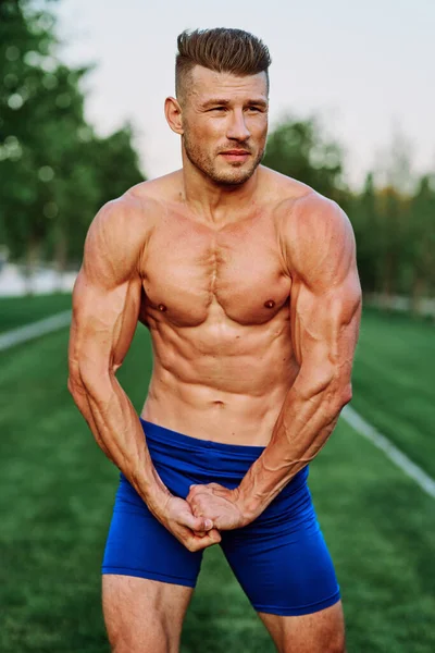 Man with pumped up muscular body outdoors health workout — Stock Photo, Image