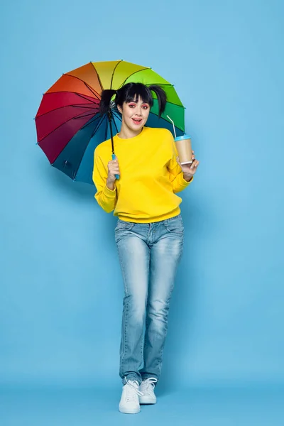 Mujer alegre con paraguas de color arco iris posando estilo de calle — Foto de Stock