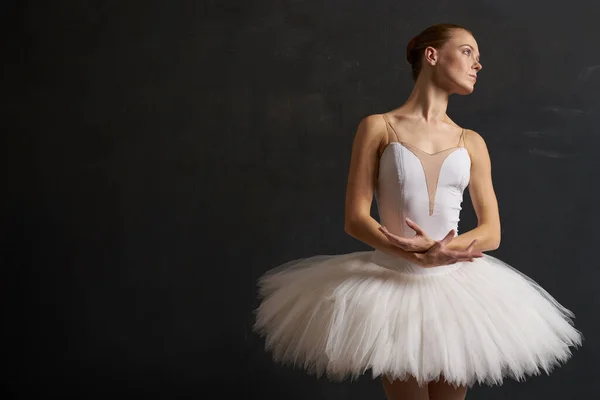 Ballerina i en hvid tutu danseforestilling silhuet mørk baggrund - Stock-foto