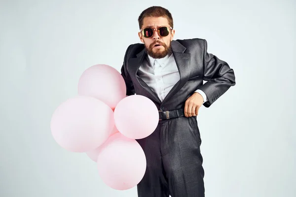 Business man in a suit sunglasses office balloons — Stock Photo, Image