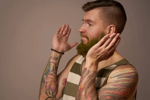 National bearded man in a striped jersey hipster tattoos on his arms — Stock Photo, Image