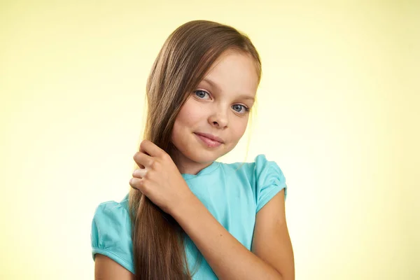 Cheerful little girl with long hair close-up studio posing — Stock Photo, Image