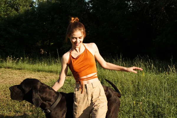 Cheerful woman outdoors with dog and fun nature — Stock Photo, Image