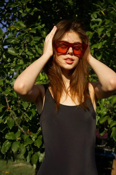 Woman in black swimsuit sunglasses nature summer posing — Stock Photo, Image