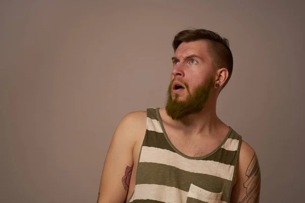 National bearded man in a striped jersey hipster tattoos on his arms — Stock Photo, Image