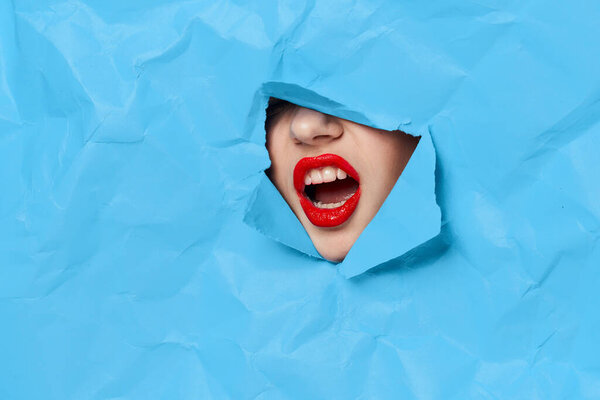 womans face breaks through blue mockup close-up