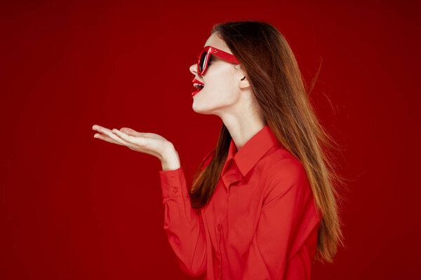 beautiful woman wearing sunglasses red shirt makeup isolated background
