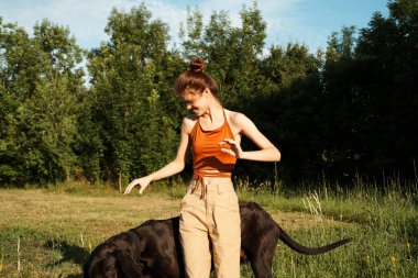 Dışarıda, dışarıda köpek arkadaşlığı oynayan bir kadın.
