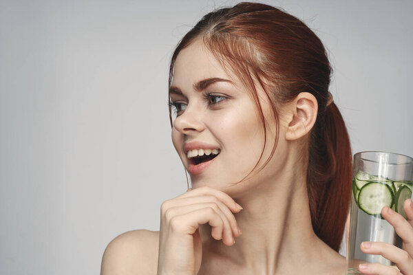 woman with cucumber drink health vitamins close-up