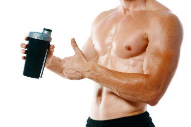 Şişirilmiş gövdesi olan atletik bir adam. Spor tükürüğü şişesi içiyor.
