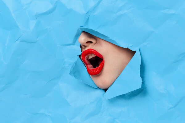 womans face breaks through blue mockup close-up