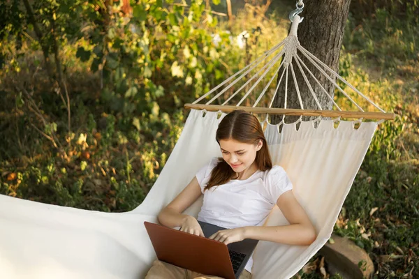 Kobieta leży na hamaku z laptopa podróży wakacje internet — Zdjęcie stockowe