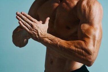 Şişkin üstsüz erkek vücut geliştirici pozu veren kas egzersizi yapıyor.