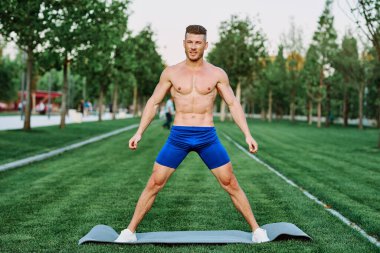 Sportif kaslı adam spor için parktaki spor motivasyonuna gidiyor.