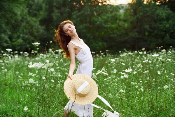 Cheerful woman in a field outdoors flowers fresh air freedom — Stock Photo, Image