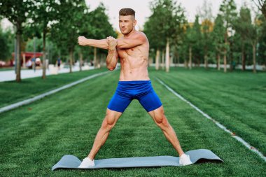 Sportif kaslı adam spor için parktaki spor motivasyonuna gidiyor.