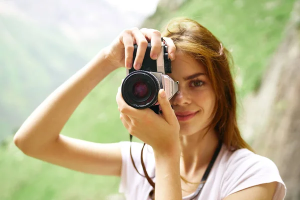 Woman photographer in the mountains outdoors travel hobby — Stock Photo, Image