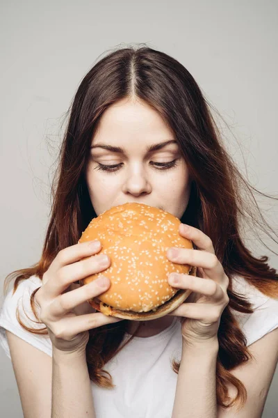 Kobieta z hamburgerem w rękach przekąska fast food zbliżenie — Zdjęcie stockowe