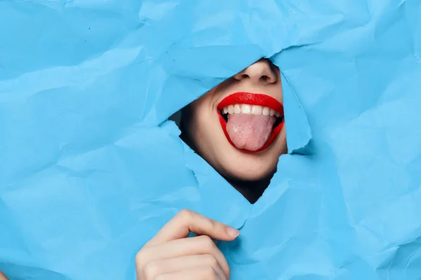 Mujeres cara rompe a través de azul maqueta de primer plano — Foto de Stock