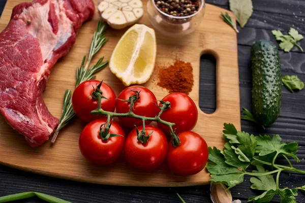 Tahta bir bifteğin üzerindeki et sebzeleri.