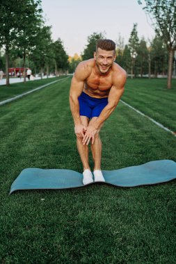 Parktaki şortlu sporcu dışarıda çalışıyor.