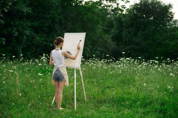 woman artist in aprons paint palette easel nature