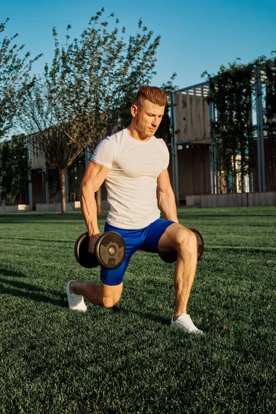 Man in the park green grass workout fitness exercise — Stock Photo, Image