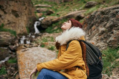 Sırt çantalı kadın yürüyüşçü dağlarda yolculuk özgürlüğü.