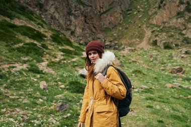 Sırt çantalı kadın yürüyüşçü dağlarda yolculuk özgürlüğü.