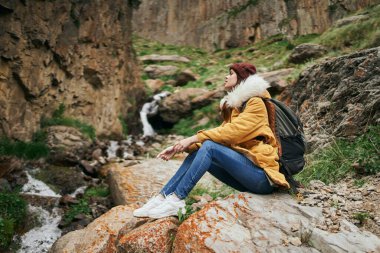 Sırt çantalı kadın yürüyüşçü dağlarda yolculuk özgürlüğü.