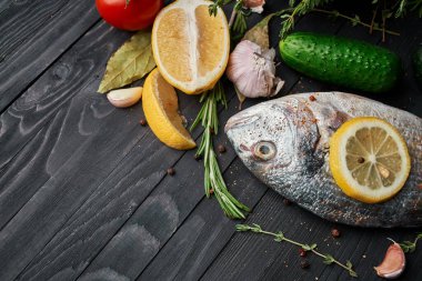 Tahta üzerinde balık. Malzemeler limon taze deniz ürünleri.