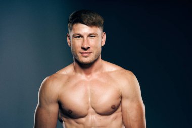 Atletik erkek üstsüz kas geliştirici koyu arkaplan