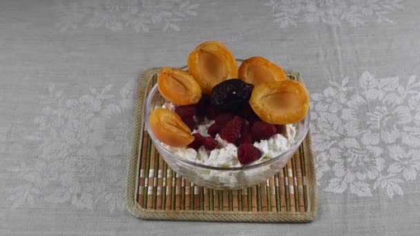 Womans Hand Beautifully Puts Prunes Glass Bowl Cottage Cheese Slices — Stockvideo