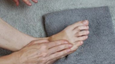 A woman massages her toes after a pedicure. Foot care. The concept of healthy legs. Womens health.