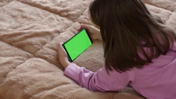 Little Girl Years Old Uses Smartphone Preconfigured Green Screen Several — стоковое видео