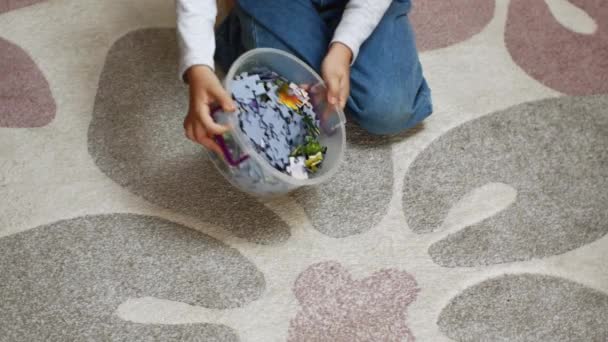Girl Sitting Rug Chooses Colorful Puzzle Pieces Sorts Them Preschool — Stockvideo