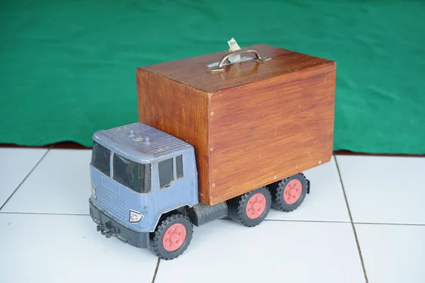 A toy truck loaded with wooden boxes