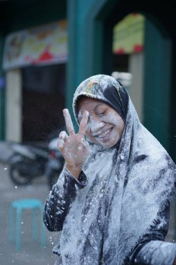 Bir kız, doğum gününde unla atılır.