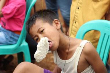Cracker eating competition to commemorate Indonesia's independence day