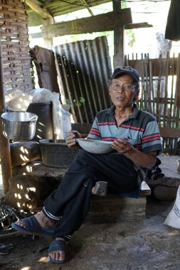An old blacksmith is making a pot