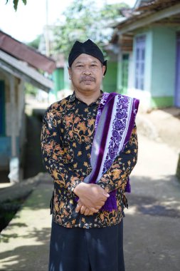 A javanese man is standing