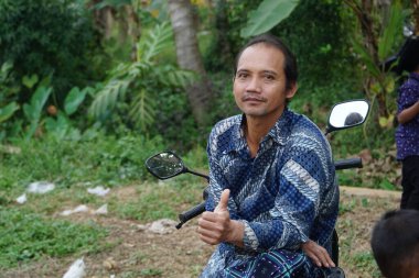 Man in batik shirt looking at camera